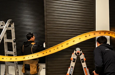 Two installers fitting tall interior shutters